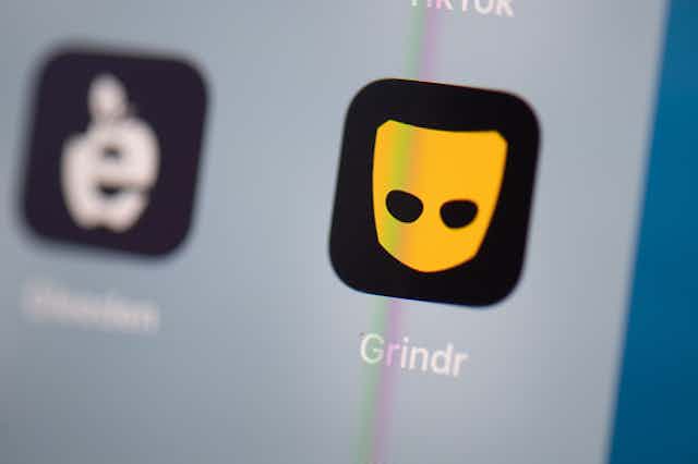 The black and yellow Grindr app icon on a smartphone sceen.