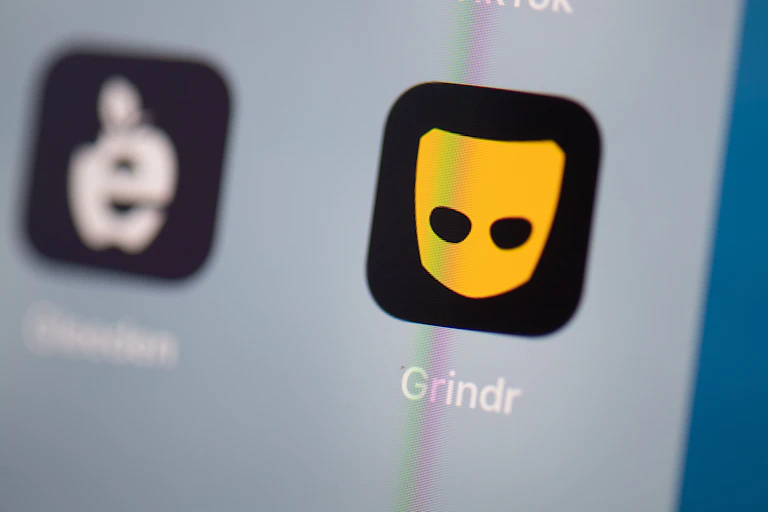 The black and yellow Grindr app icon on a smartphone sceen.
