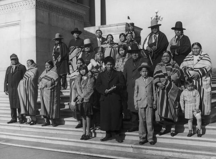 Members of the Osage Nation from Oklahoma stand on the steps of the Capitol in Washington D.C.