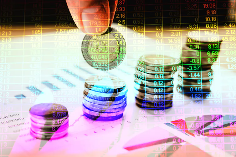 Coins stacked on graphs and charts.