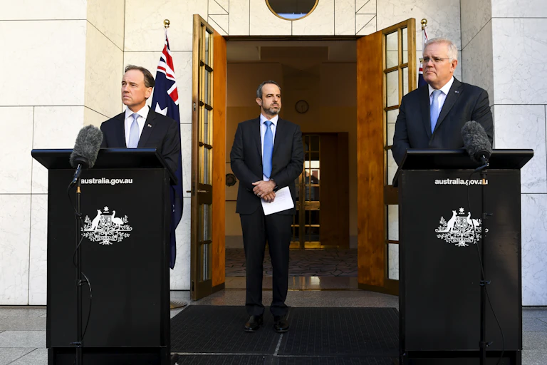 The AMA president stands between the health minister and prime minister.