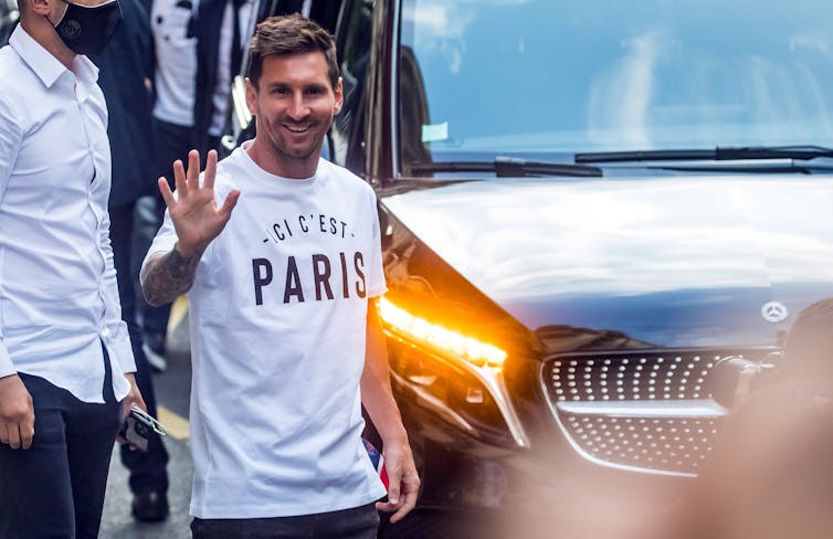Messi waves to supporters in Paris.