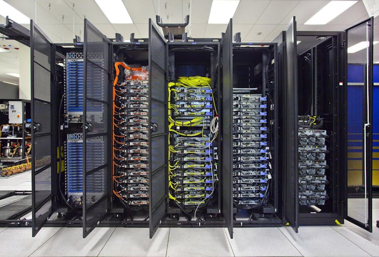 A stack of computer servers with brightly coloured wires