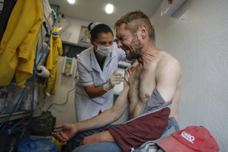 Man grimaces as he receives COVID-19 vaccine