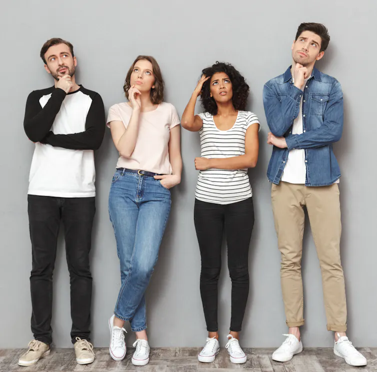 Four people who all appear to trying to remember something.