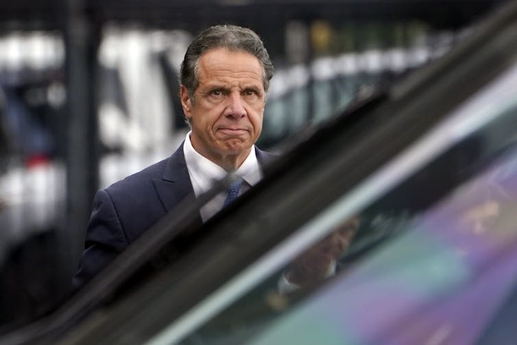 New York Gov. Andrew Cuomo grimaces as he prepares to board a helicopter