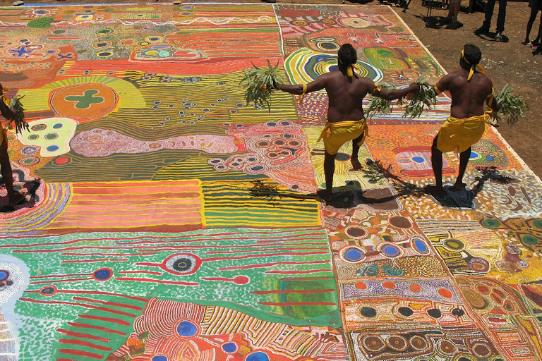 Indigenous dancers from WA's remote Kimberley region standing on the Ngurrara Canvas.