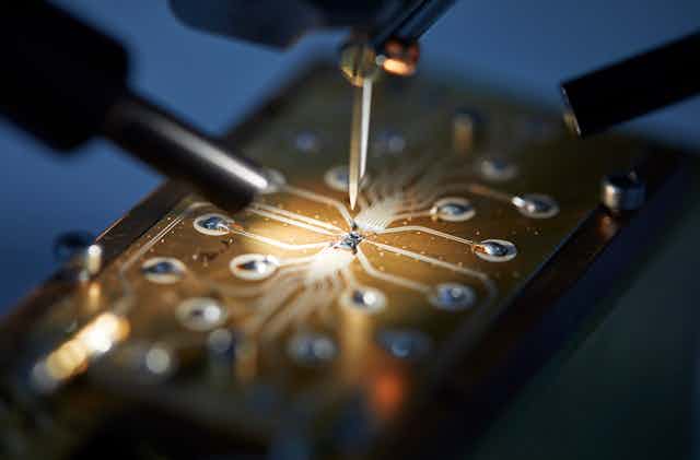Qubit device being connected to a circuit board in preparation for measurement. 