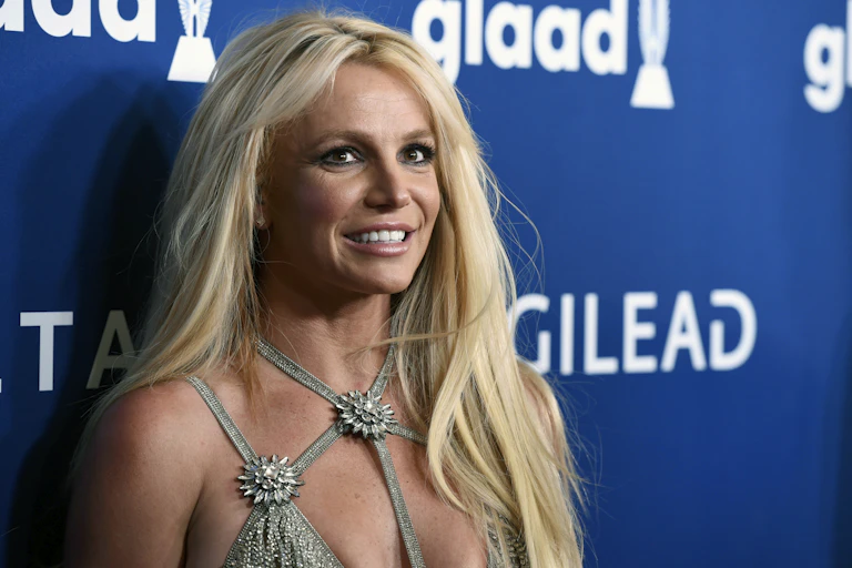 Britney Spears stands at a red carpet event.