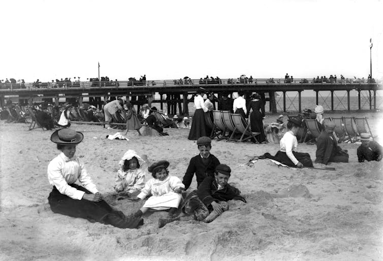 Victorian holidaymakers on a beach.