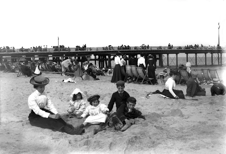 Victorian holidaymakers on a beach.