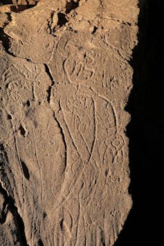 etched outline of a figure instone