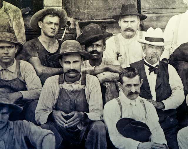 A group of men pose in an 1870 photograph.