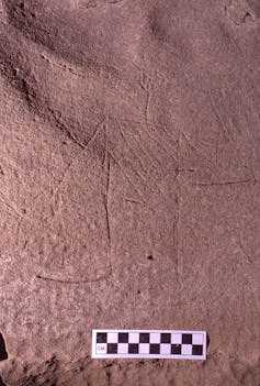 Outline of a human etched into stone