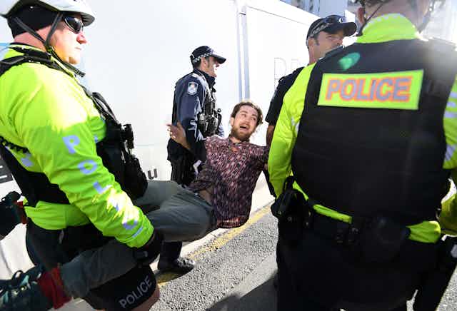 An Extinction Rebellion protester is arrested in 2019.