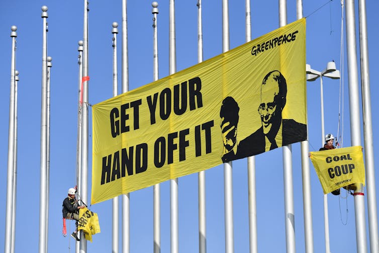 An anti-coal banner is hung by activists at federal parliament in 2018.