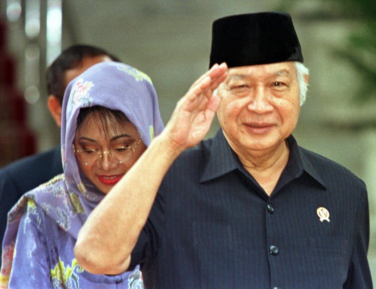 Soeharto salutes after his 1998 resignation.