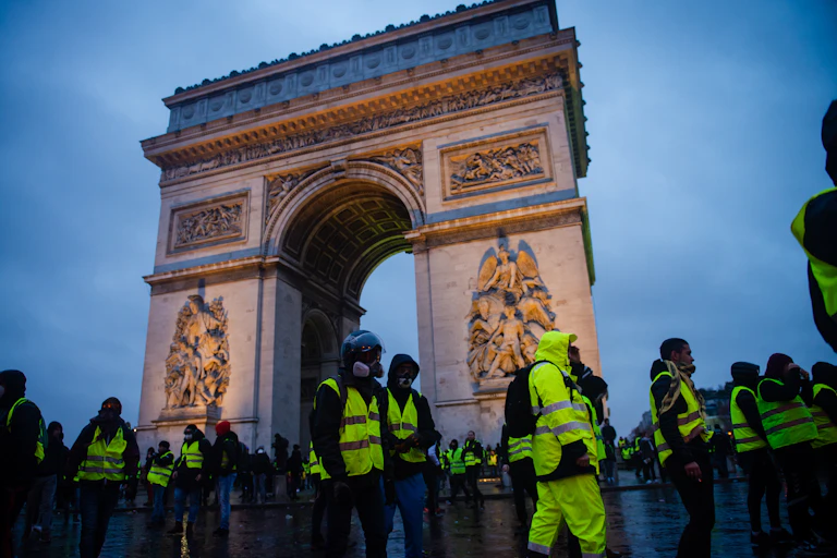 Paris, France - December 01, 2018 : The Gilets Jaunes, or “Yellow Vest”, protestors clash with police while demonstrating against the government of President Macron near the Arc de Triomphe.