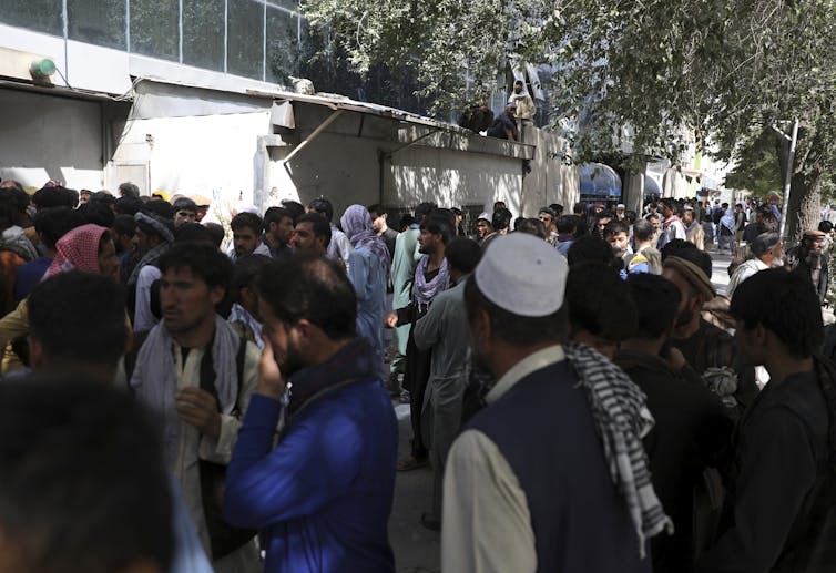 Crowds of Afghans trying to take money out of the bank in Kabul.