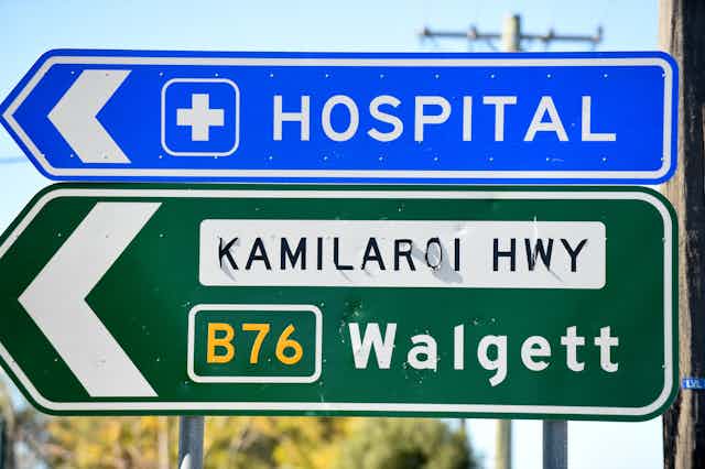A road sign showing hospital and Walgett