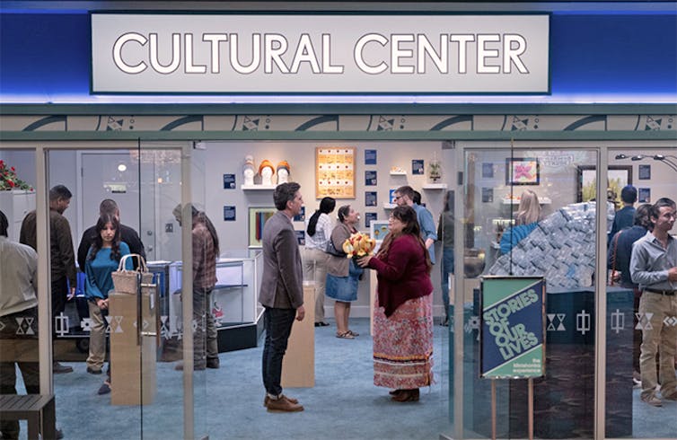 Characters stand in a 'cultural centre'