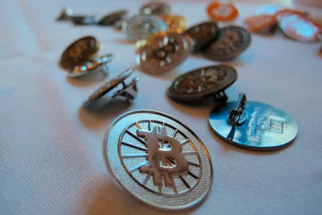A bunch of bitcoin buttons are sitting on a table