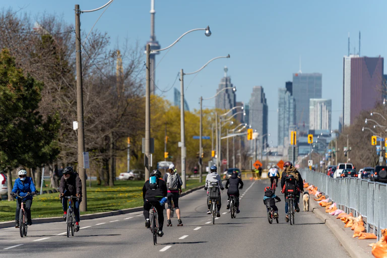 People bike and rollerblade down a closed road