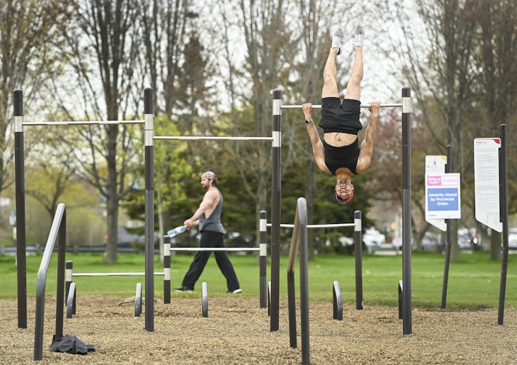 People work out at an outdoor gym located along Lake Ontario during COVID-19 in Toronto.