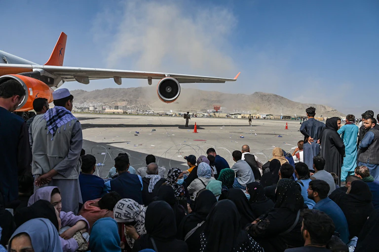 Afghan people waiting to leave the Kabul airport in Kabul on Aug.16, 2021.