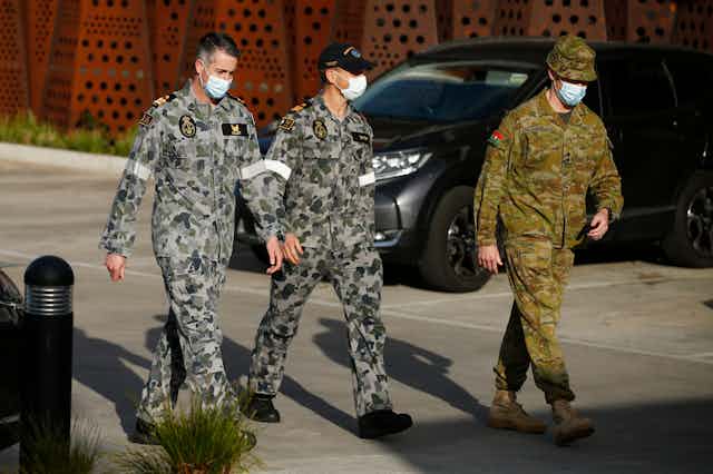 Military personnel wearing facemasks at an aged care facility in Melbourne