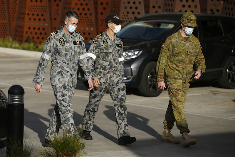 Military personnel wearing facemasks at an aged care facility in Melbourne
