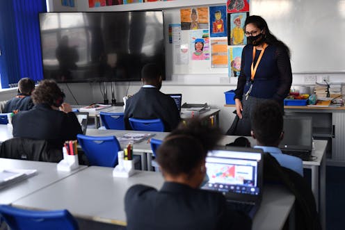 A teacher speaks to students in a classroom at the Jewellery Quarter Academy in Birmingham in the West Midlands