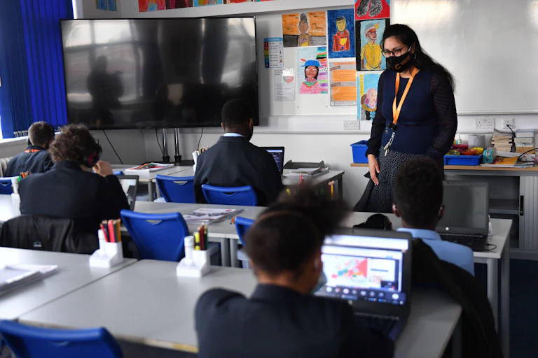 A teacher speaks to students in a classroom at the Jewellery Quarter Academy in Birmingham in the West Midlands