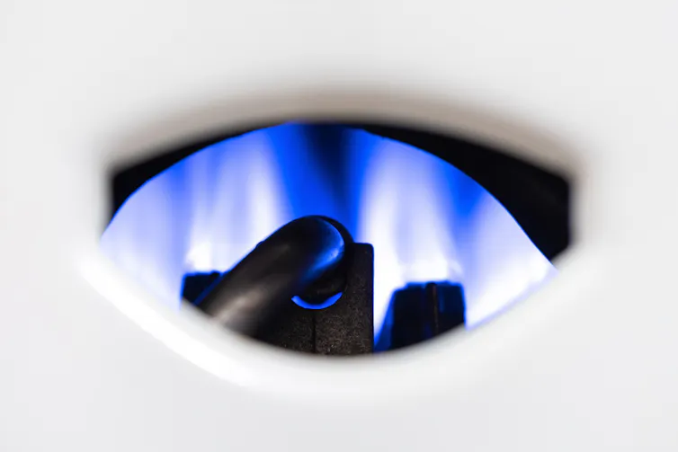 The blue pilot light of a gas boiler.