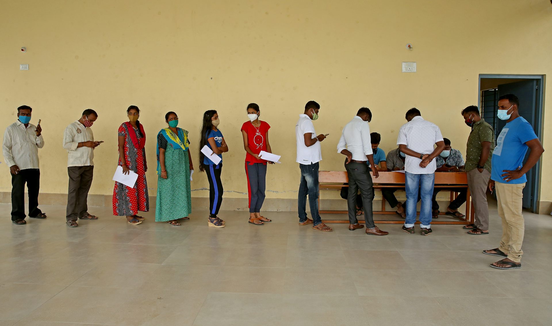 A queue of people waiting at a COVID-19 vaccination centre in India