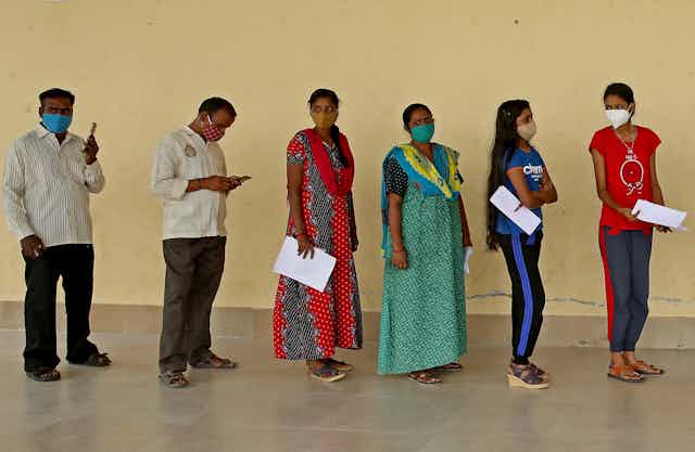 A queue of people waiting at a COVID-19 vaccination centre in India