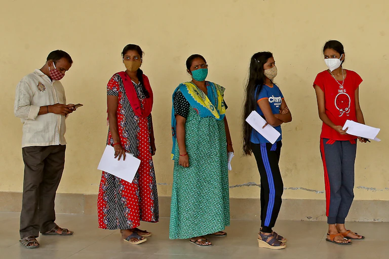A queue of people waiting at a COVID-19 vaccination centre in India