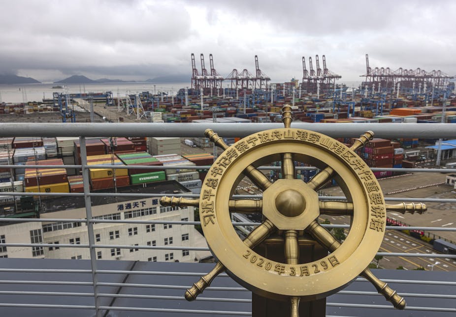 A commemorative ship's wheel overlooking the port of Ningbo-Zhousan