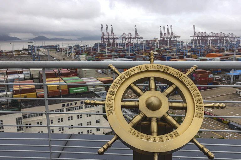 A commemorative ship's wheel overlooking the port of Ningbo-Zhousan