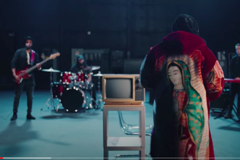 Musician Shelly, formerly known as formerly known as D.R.A.M, wearing designer Brenda Equihua's outerwear which has the image of Mary displayed at the back.