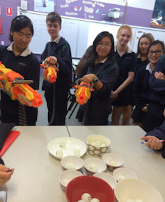 Students use nerf guns to model photons ejecting electrons