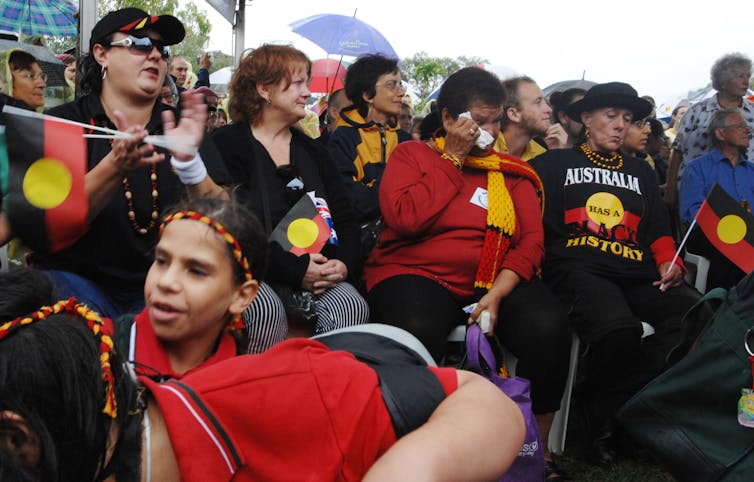 Aboriginal community members watch the Australian government apology.