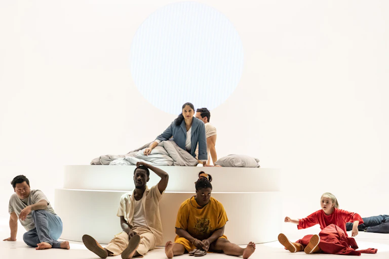 A group of characters on a white stage