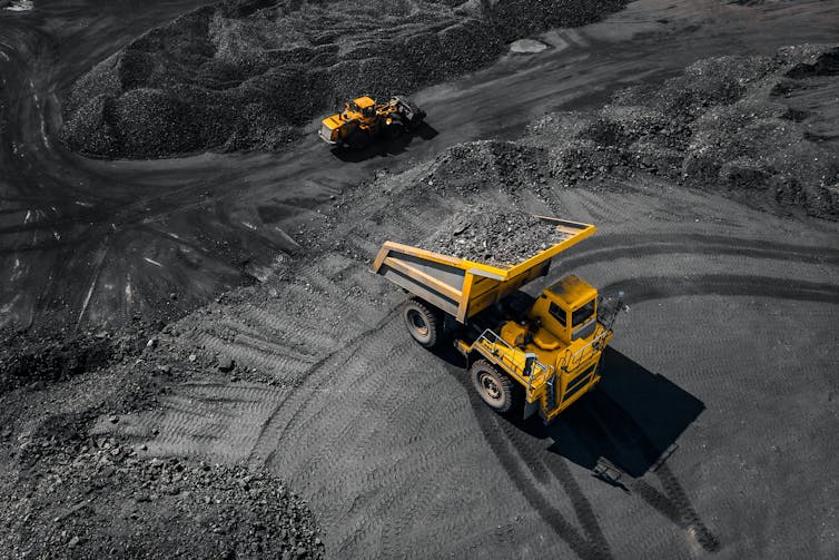 Two trucks in an open pit coal mine