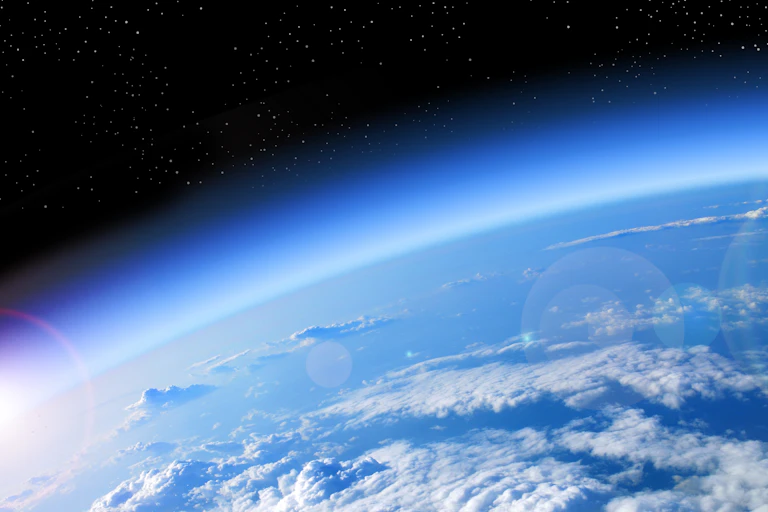 The curvature of the Earth with a blue haze surrounding it.