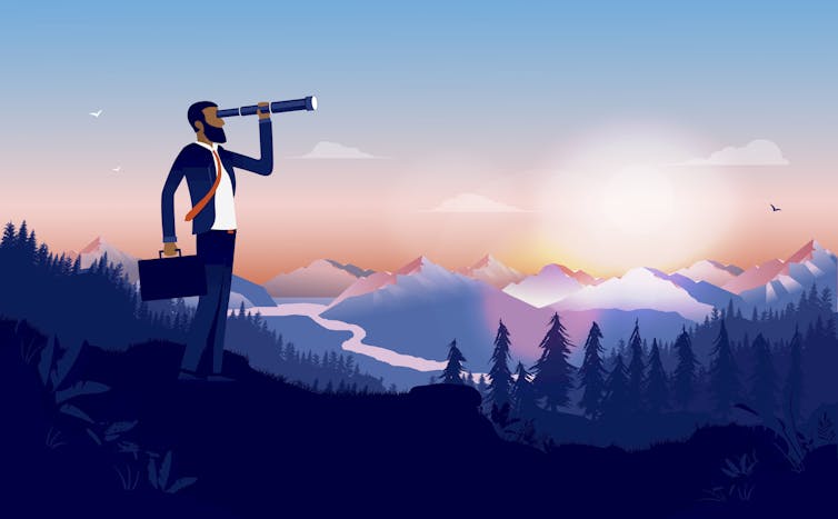 Businessman looks for opportunities in a wide landscape.