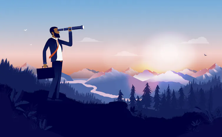 Businessman looks for opportunities in a wide landscape.