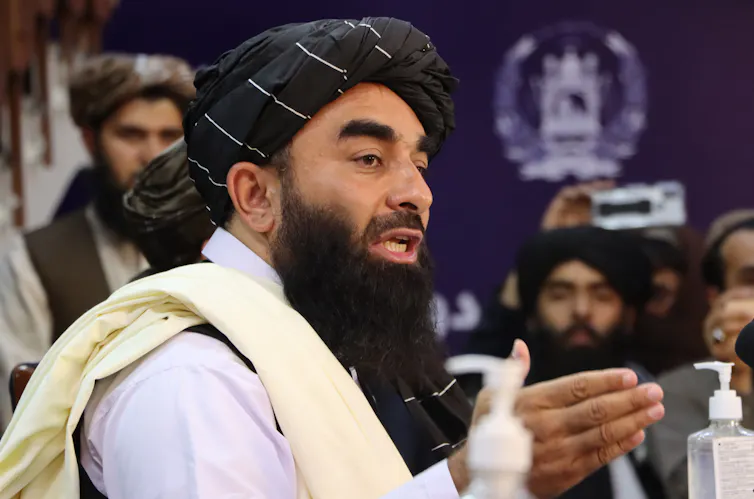 Zabihullah Mujahid speaking at a press conference.