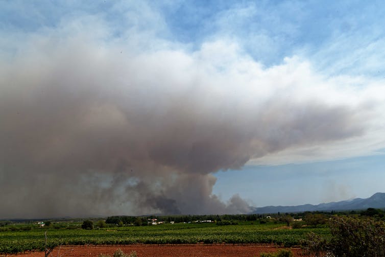A column of smoke above a French landscape.