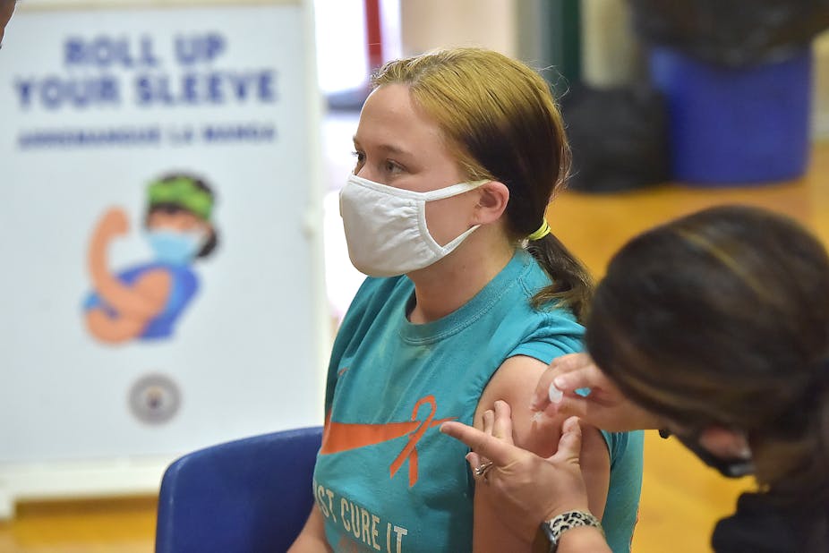 Junior Molly Day gets her first Pfizer Biontech COVID vaccine at Ridley High School Monday afternoon May, 3, 2021 as part of a clinic for students age 16-18. 